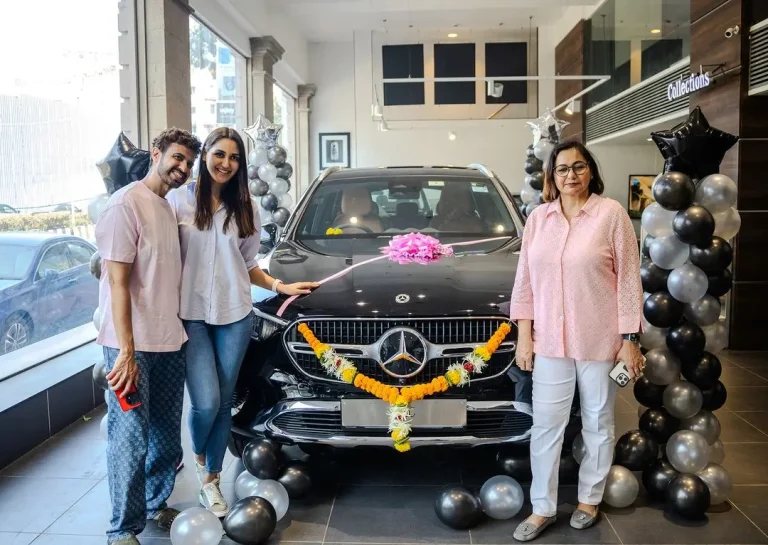 a group of people standing next to a car